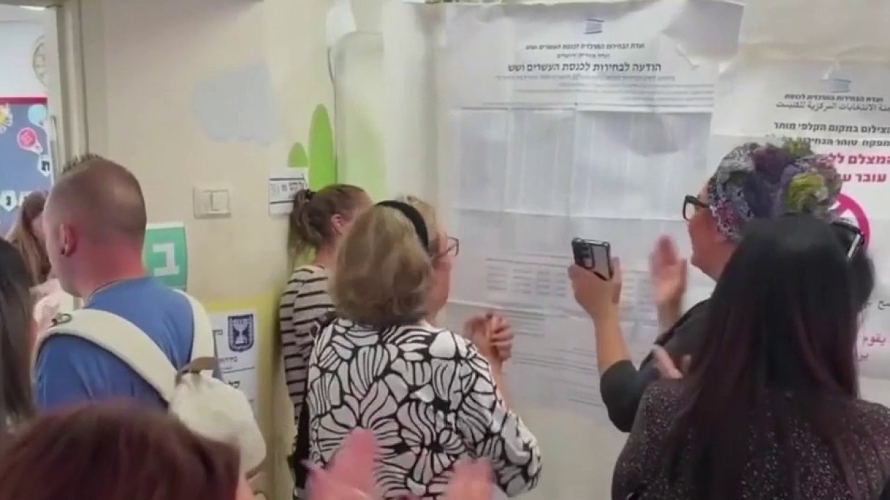 Israeli flag waving over the Knesset building in Jerusalem at sunset, symbolizing political uncertainty.